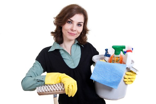 Upholstery cleaning equipment used on a living room sofa